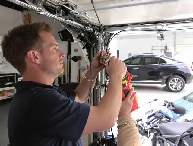 Norton Garage Door Repair safety certified technician performing cable replacement in Norton